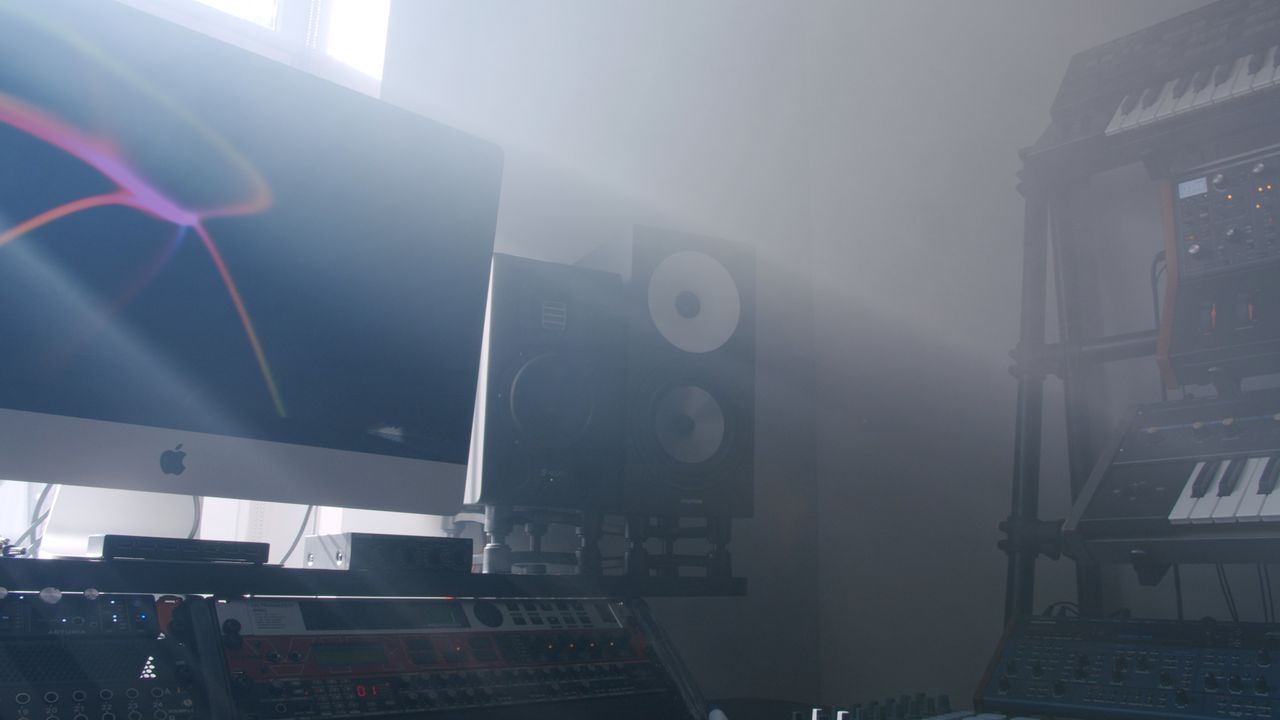 Stylish recording studio featuring audio equipment and ambient lighting.